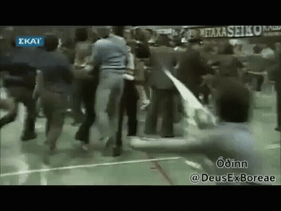 A Group Of People Are Dancing On A Basketball Court In A Gym . GIF