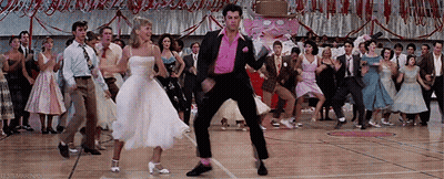 A Group Of People Are Dancing On A Dance Floor In A Gym . GIF