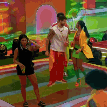 a group of people are dancing on a stage in a colorful painting
