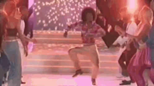 A Group Of People Are Dancing On A Stage In A Disco . GIF