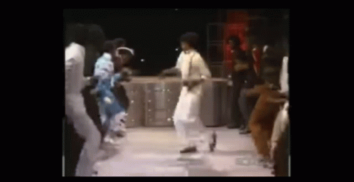 A Group Of People Are Dancing On A Stage In Front Of A Crowd . GIF