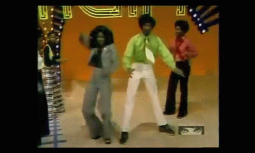 A Group Of People Are Dancing On A Stage In Front Of A Crowd . GIF