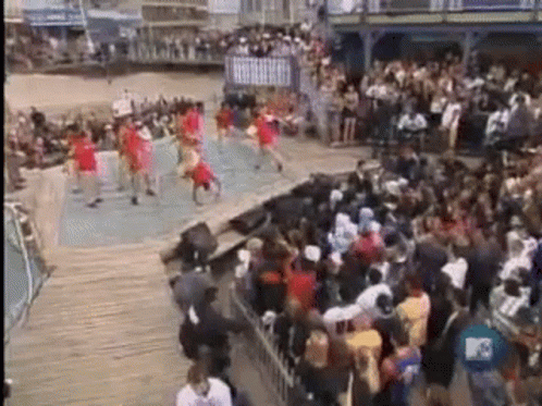 A Group Of People Are Dancing On A Stage In Front Of A Crowd Of People . GIF