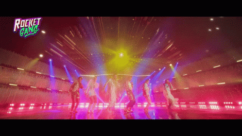 A Group Of People Are Dancing On A Stage With A Rocket Gang Logo GIF