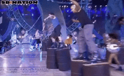 A Group Of People Are Dancing On A Stage With A Sign That Says Senation GIF