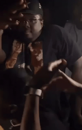 A Group Of People Are Dancing Together In A Dark Room At A Party . GIF