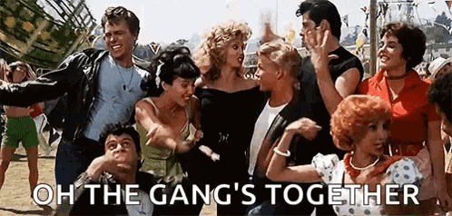 A Group Of People Are Dancing Together In A Park And The Words `` Oh The Gang 'S Together '' Are Written Above Them . GIF