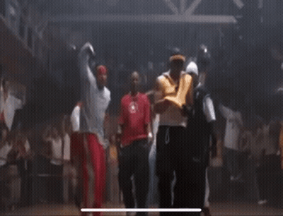 A Group Of People Are Dancing Together On A Dance Floor In A Dark Room . GIF