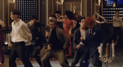 A Group Of People Are Dancing Together On A Dance Floor In A Room . GIF