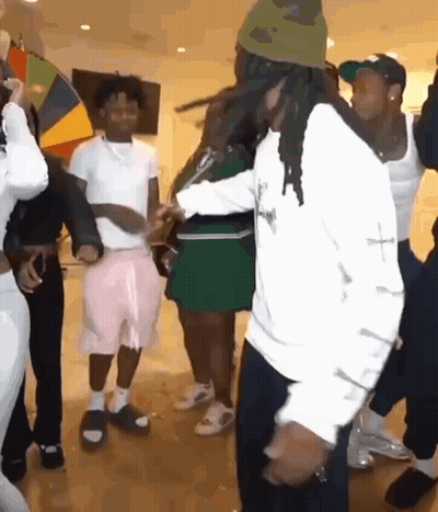 A Group Of People Are Dancing Together On A Dance Floor In A Room . GIF