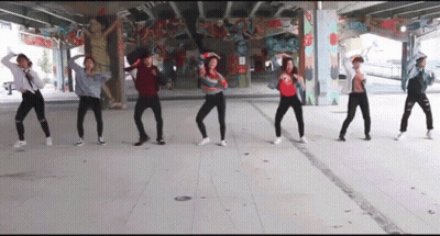 A Group Of People Are Dancing Under A Bridge In Front Of A Graffiti Wall . GIF