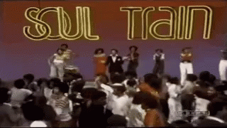A Group Of People Are Dancing Under A Sign That Says Soul Train GIF