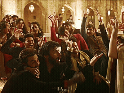 A Group Of People Are Dancing With Their Hands In The Air And The Word Shulgg Is Visible In The Corner GIF