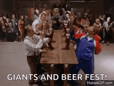 A Group Of People Are Drinking Beer At A Long Table . GIF