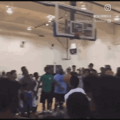 A Group Of People Are Gathered Around A Basketball Hoop With A Caption That Says Calebreels On It GIF