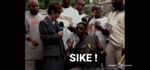 A Group Of People Are Gathered Around A Man With The Word Sike On The Bottom Right GIF