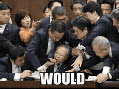 A Group Of People Are Gathered Around A Table With The Word Would Written On It GIF
