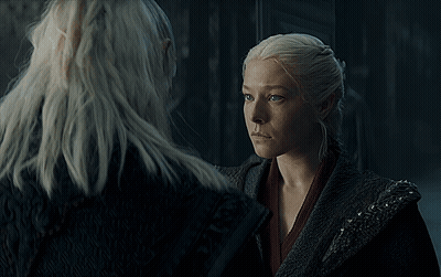 A Group Of People Are Gathered In A Dark Room With A Castle In The Background GIF