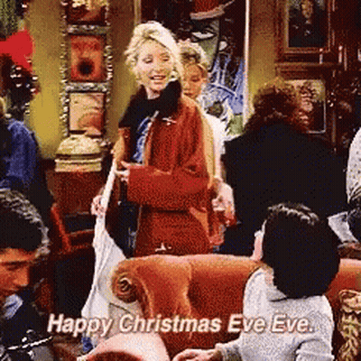 A Group Of People Are Gathered In A Living Room And One Of Them Says " Happy Christmas Eve Eve " GIF