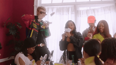 A Group Of People Are Gathered In A Room And One Of Them Is Wearing A Jacket That Says Supreme On It GIF