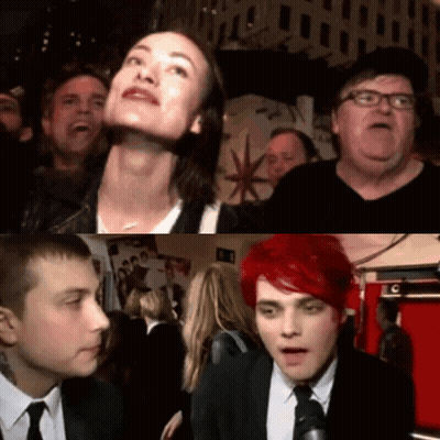 A Group Of People Are Gathered In A Room With A Sign That Says C On It GIF