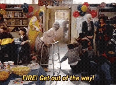 A Group Of People Are Gathered In A Room With Balloons And The Words Fire Get Out Of The Way GIF