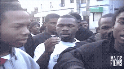 A Group Of People Are Gathered In Front Of A Building That Says Major Films On The Bottom GIF