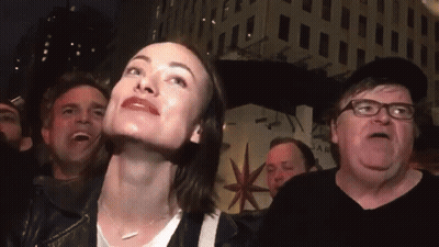 A Group Of People Are Gathered In Front Of A Building That Says Star On It GIF