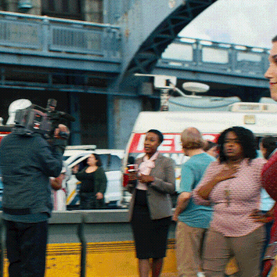 A Group Of People Are Gathered In Front Of A Van That Says ' Ee ' On It GIF