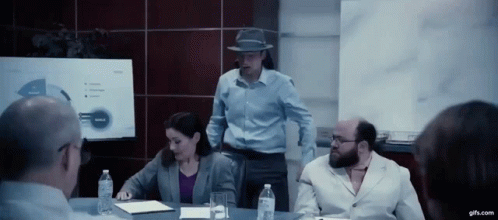 A Group Of People Are Having A Meeting In A Conference Room GIF