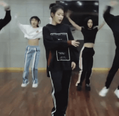 A Group Of People Are Jumping In The Air While Dancing In A Dance Studio . GIF