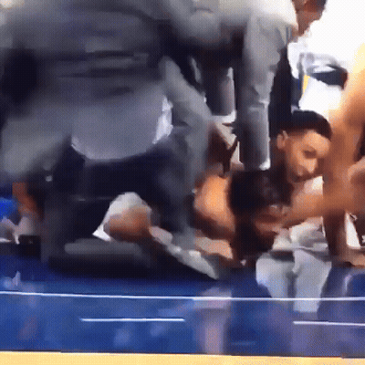 A Group Of People Are Kneeling Down On A Blue Floor GIF
