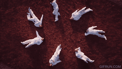 A Group Of People Are Laying In A Circle With The Website Gifrun.com In The Corner GIF