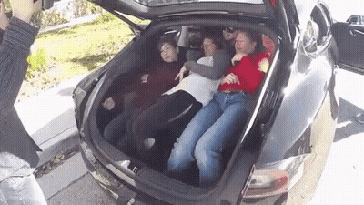 A Group Of People Are Laying In The Back Of A Car GIF