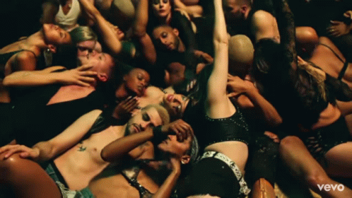 A Group Of People Are Laying On The Floor With The Word Vevo On The Bottom Right GIF