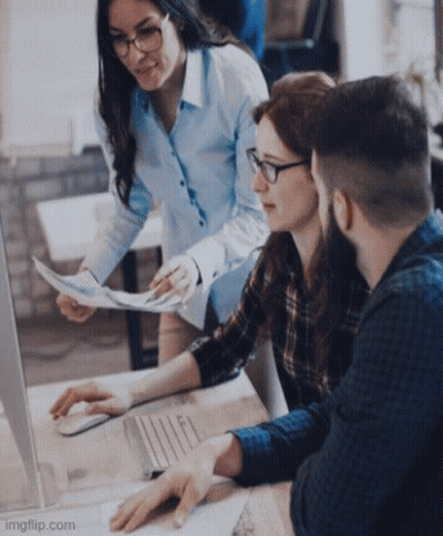 A Group Of People Are Looking At A Computer Screen While A Woman Holds A Piece Of Paper . GIF