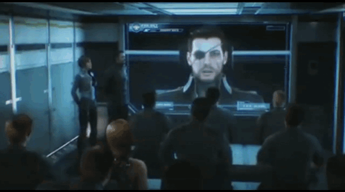 A Group Of People Are Looking At A Screen With A Man 'S Face On It That Says Eclipse GIF