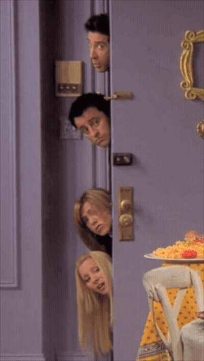 A Group Of People Are Peeking Out Of A Door GIF