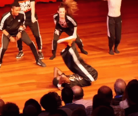 A Group Of People Are Performing On A Stage And One Has A Shirt That Says Run Nyc On It GIF
