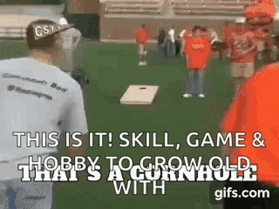 A Group Of People Are Playing A Game Called Cornhole . GIF