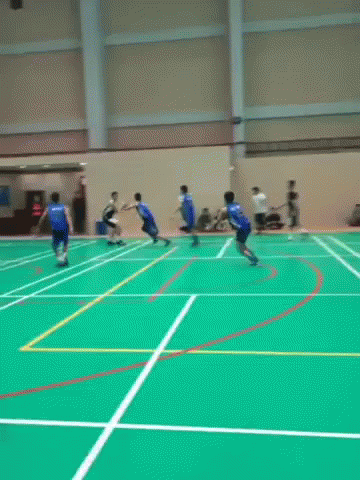 A Group Of People Are Playing A Game Of Basketball On A Court . GIF