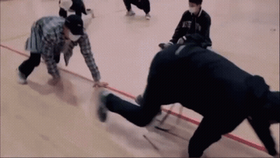 A Group Of People Are Playing A Game On A Basketball Court And One Of Them Is Wearing A Mask That Says Nfc GIF