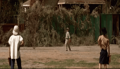 A Group Of People Are Playing Baseball In A Field GIF