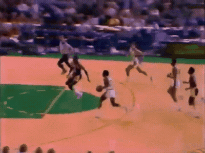 A Group Of People Are Playing Basketball On A Court With A Referee In The Background GIF