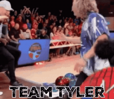 A Group Of People Are Playing Bowling In Front Of A Crowd And The Words Team Tyler Are Written On The Floor . GIF