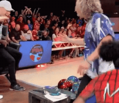 A Group Of People Are Playing Bowling In Front Of A Screen That Says Bowl Tech GIF