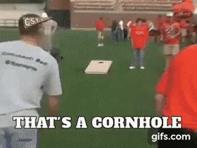 A Group Of People Are Playing Cornhole On A Field And The Caption Says That 'S A Cornhole GIF