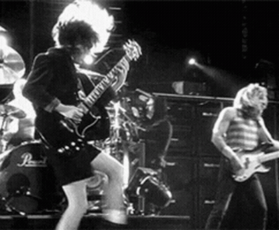 A Group Of People Are Playing Guitars On A Stage . GIF