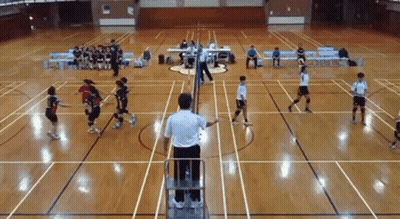 A Group Of People Are Playing Volleyball On A Court While A Referee Watches . GIF