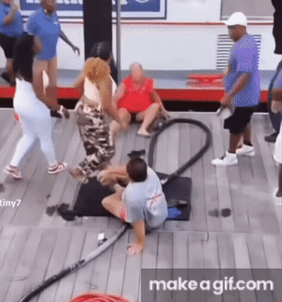 A Group Of People Are Playing With A Vacuum Cleaner On A Wooden Floor . GIF